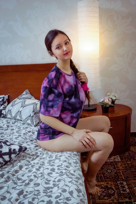 Teen with big tits Adeline unveils her hairy cunt and poses on her bed